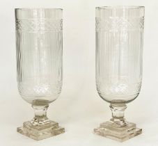 STORM LANTERNS, a pair, cylindrical cut and engraved glass on stepped plinth bases, 40cm H. (2)