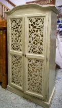 CABINET, 111cm x 196cm H x 56cm, green painted with a pair of decorative pierced grilled doors