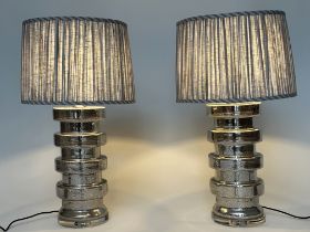 TABLE LAMPS, a pair, silvered glass of circular ribbed drum form with pleated shades from India