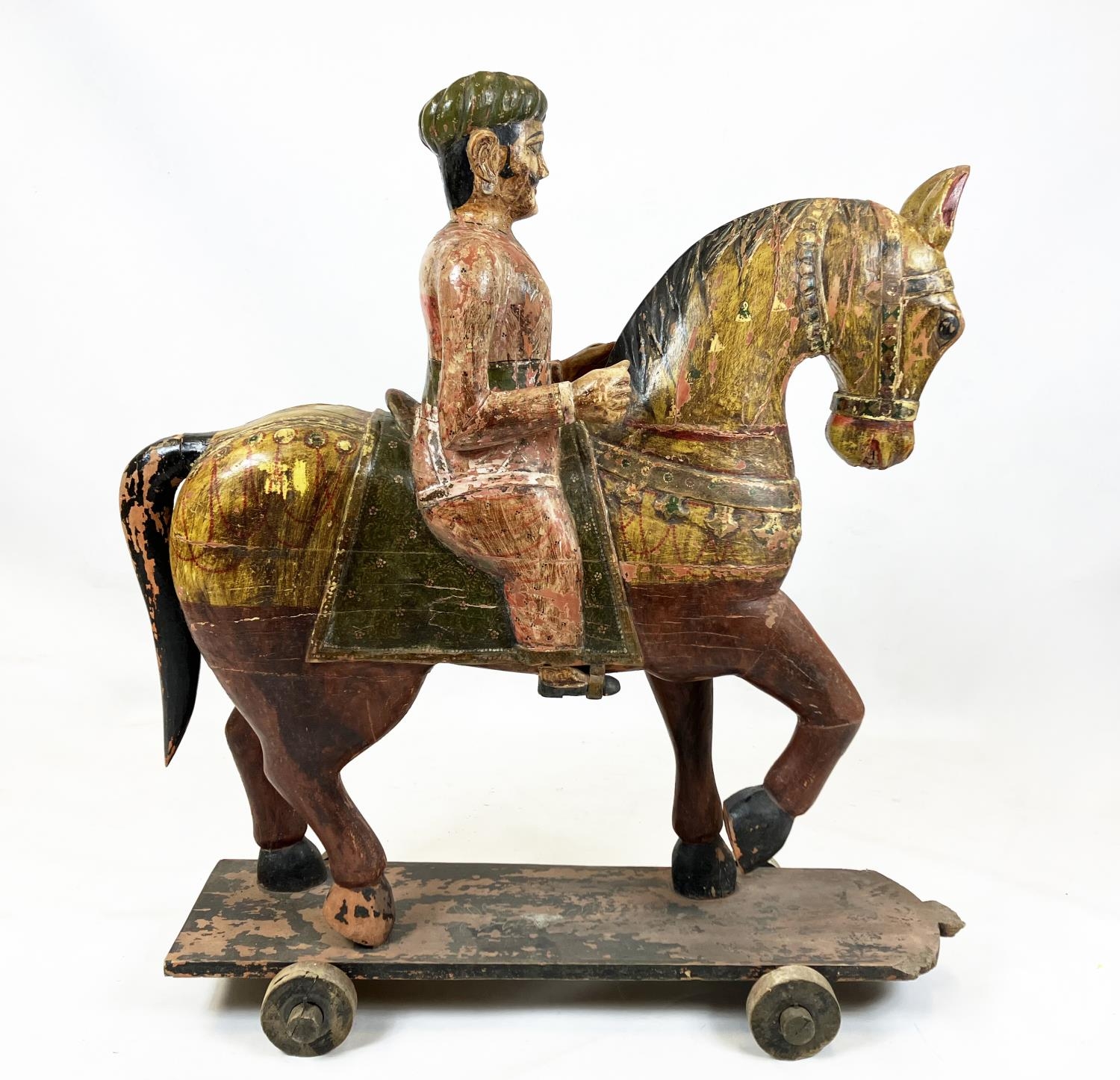 MUGHAL SCHOOL RAJASTHAN INDIA, 'Horse and rider', polychrome painted carved wood, 109cm H.