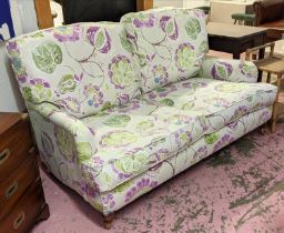 HOWARD STYLE SOFA, two seater, with vibrant botanical print upholstery, turned front supports and