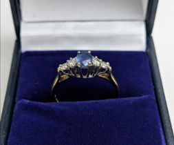 A 9CT YELLOW GOLD SAPPHIRE AND DIAMOND FIVE STONE RING, the central sapphire of 0.50 carat, the
