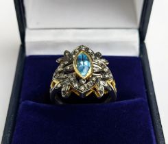A VICTORIAN STYLE SILVER-GILT TOPAZ DRESS RING, the central stone of 0.30 carats surrounded by