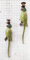 WALL SCONCES, a pair, in the form of parrots, glazed ceramic, gilt mounts, 47cm L each. (2)
