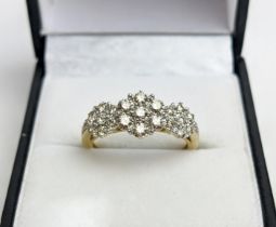 A 9CT YELLOW GOLD DIAMOND CLUSTER DRESS RING, set with three clusters of seven diamonds, total