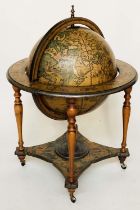 GLOBE COCKTAIL CABINET, in the form of an antique, terrestrial globe on stand with rising 'lid'