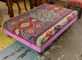 KILIM FOOTSTOOL, raised on turned supports and castors, 35cm H x 123cm x 83cm.