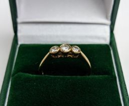 A 9CT YELLOW GOLD THREE STONE DIAMOND TRILOGY RING, set with round brilliant cut stones of