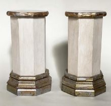 COLUMNS/PLINTHS, a pair, octagonal grey painted, facetted with silvered wood, stepped plinths and