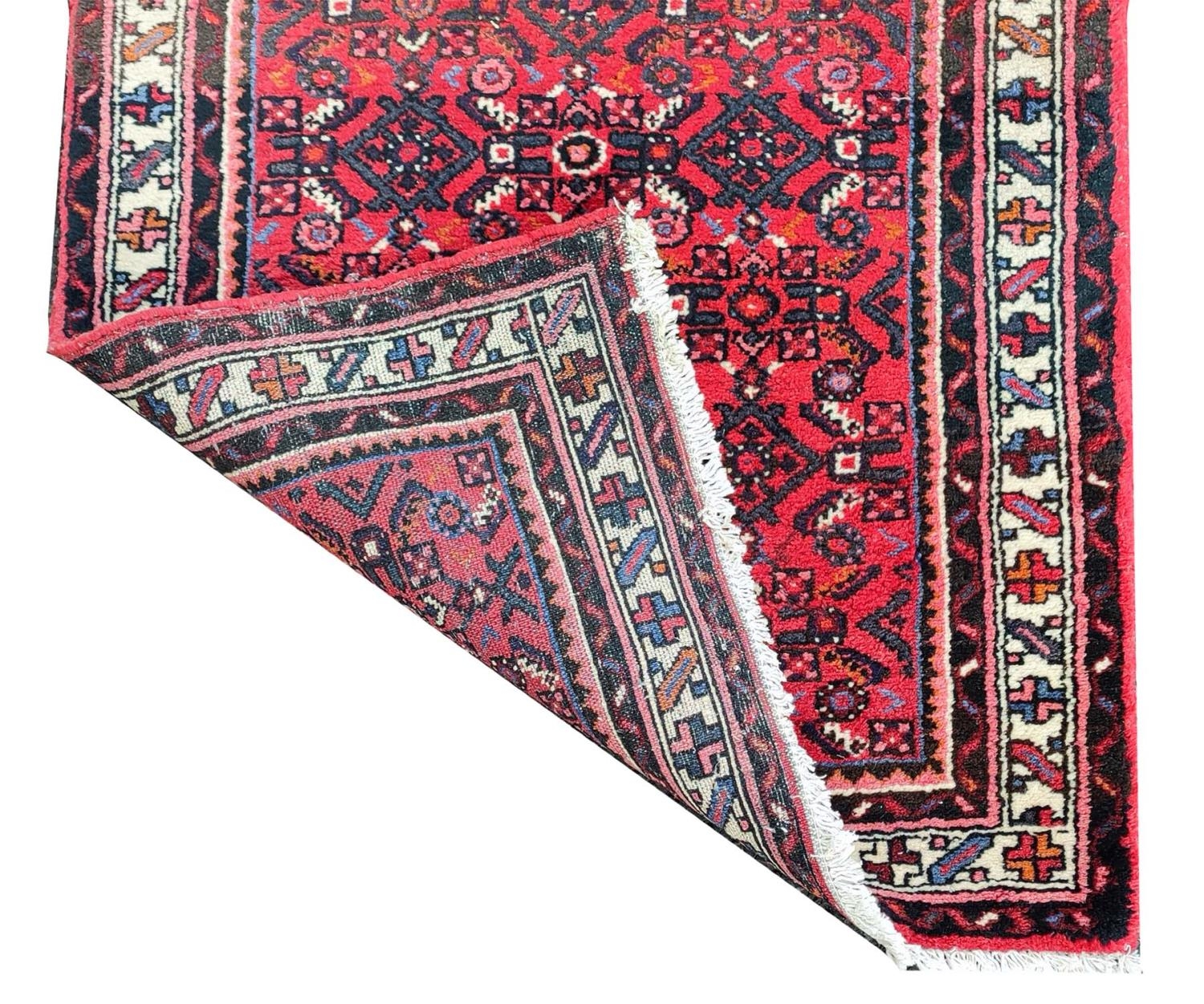 LARGE PERSIAN HOSSEINABAD CRIMSON GROUND RUNNER, 514cm L x 84cm W. - Image 6 of 14