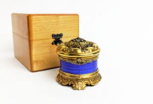 A FABERGE SILVER GILT AND BLUE ENAMELLED CIRCULAR BOX, embossed lid set with ruby and diamonds, with