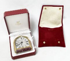 CARTIER ROUIANE ALARM CLOCK, Must de Cartier, arched dial in gilt metal and red enamel case in