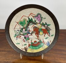CHINESE STONEWARE PLATE, decorated with battle scene in bright enamels, 33cm diam.