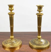 CANDLESTICKS, a near pair, 19th century gilt brass, 27cm H. (2)