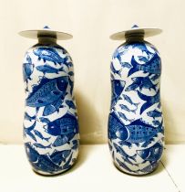 JARS WITH COVERS, a pair, blue and white ceramic with carp decoration, 44cm high, 17cm diam. (2)