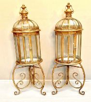 STORM LANTERNS ON STANDS, 115cm H x 34cm diam., Regency style, gilt metal frames. (2)