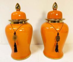 TEMPLE JARS, a pair, 60cm high, 34cm diameter, glazed ceramic, orange body and gold rims. (2)