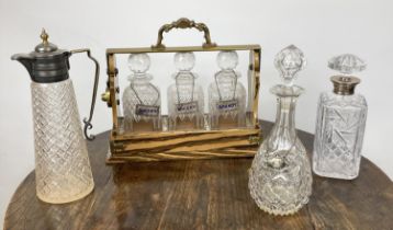 BETJEMANNS VICTORIAN PATENT TANTALUS, having three cut glass decanters in simulated rosewood case