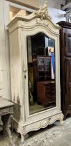 ARMOIRE, late 19th century French in a distressed painted finish, with mirrored door enclosing