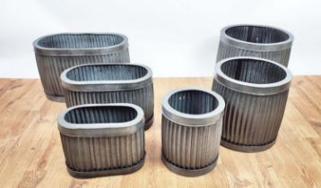 PLANTERS, two graduated sets of three, ribbed metal, one set oval, the other circular in shape, 57cm