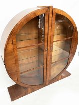 ART DECO DISPLAY CASE, figured walnut of circular form with two half round glazed doors enclosing