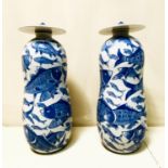 JARS WITH COVERS, a pair, blue and white ceramic with carp decoration, 44cm high, 17cm diam. (2)