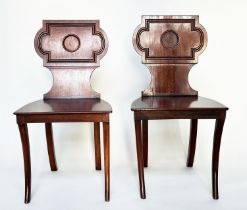 HALL CHAIRS, a pair, Regency style mahogany with cartouche inset backs and sabre front supports,