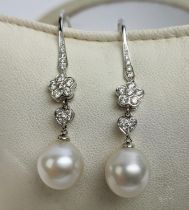 A PAIR OF 18CT WHITE GOLD PEARL AND DIAMOND PENDANT EARRINGS, hook fastenings.