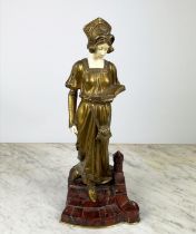D. WATRING, Art Deco gilded bronze figure of a young lady, standing reading a book, on red