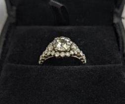 A WHITE METAL DIAMOND SET DRESS RING, probably 18ct white gold, the large round brilliant cut