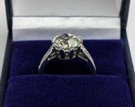 A PLATINUM AND DIAMOND SET SOLITAIRE RING, the single old mine cut diamond of approximately 2.81