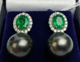 A PAIR OF 18CT WHITE GOLD EMERALD, DIAMOND AND PEARL PENDANT EARRINGS, the oval mixed cut emeralds