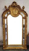 WALL MIRROR, rococo style, giltwood frame, cherub finials and a shell and foliate surmount,