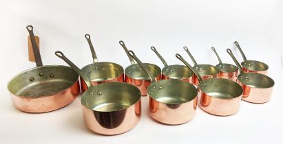 BATTERIE DE CUISINE, a set of eleven copper pans, of graduated sizes, iron handles. (11)