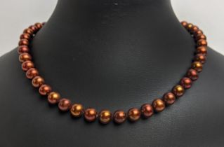 A CULTURED PEARL SINGLE STRAND NECKLACE, fitted with 47 cocoa coloured pearls of approximately 7mm