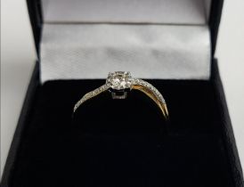 A 9CT GOLD DIAMOND SOLITAIRE RING, set with a central stone of approx. 0.20 carat, illusion set,