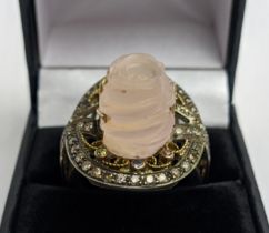 A CARVED ROSE QUARTZ AND DIAMONDS SET DRESS RING, the rose quartz of approximately 12.25ct, the