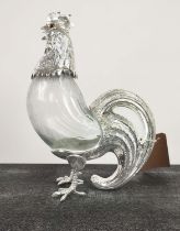 CLARET JUG, polished metal and glass, in the form of a cockerel, 36cm H x 24cm L.