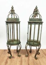 STORM LANTERNS, a pair, faux verdegris finish metal with glass panels and scrolling supports, 82cm