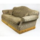 SOFA, Victorian design with camel back and scroll arms, upholstered in gold cut velvet and bullion