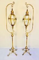 STORM LANTERNS ON STANDS, a pair, 163cm high, 35cm wide, 30cm deep, Regency style, gilt metal. (2)