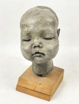 FOLLLOWER OF JACOB EPSTEIN BUST OF A BABY'S HEAD, fibre glass with a metallic finish mounted or