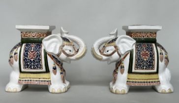 ELEPHANTS, a pair, ceramic in heraldic ceremonial regalia, 58cm W x 17cm D x 34cm. (2)