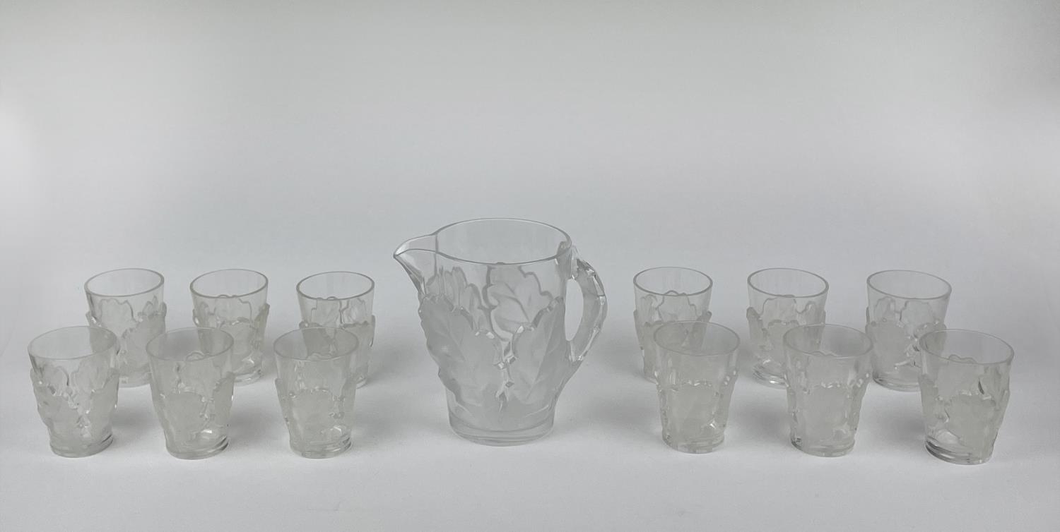 LALIQUE WATER PITCHER, frosted chene oak leaf design with twelve glasses. (13)