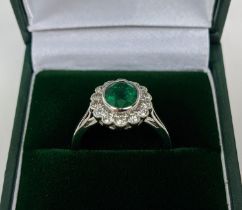 AN 18CT WHITE GOLD EMERALD AND DIAMOND DRESS RING, the central emerald of approximately 1.60 carats,