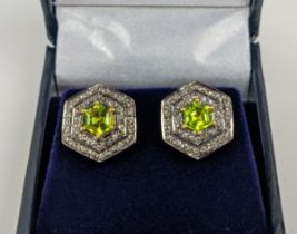 A PAIR OF STUD EARRINGS, silver gilt, hexagonal form, each set with a single peridot, surrounded