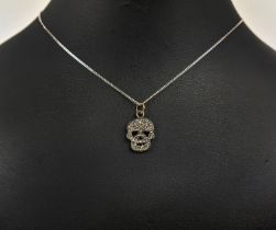 A SILVER AND DIAMOND SET SKULL PENDANT, Italian silver chain, 46cm long, complete with box.