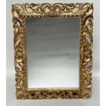 FLORENTINE WALL MIRROR, 19th century Italian rectangular carved giltwood C scroll and foliate