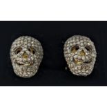 A PAIR OF SILVER-GILT MEMENTO MORI-STYLE SKULL CUFFLINKS, with pave set rose cut diamonds,