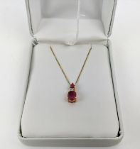 A 14CT GOLD RUBY AND DIAMOND PENDANT NECKLACE, the mixed cut rubies with a round brilliant cut